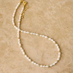 Indigo & Wolfe LACEY freshwater pearl necklace with gold accents on neutral background, shop online at Tomolly.