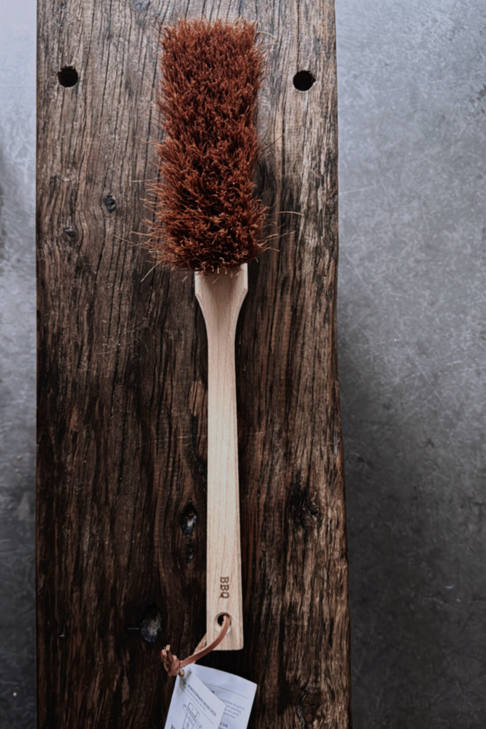 A natural BBQ brush by Redecker, crafted with coconut fibre bristles and a sturdy wooden handle.