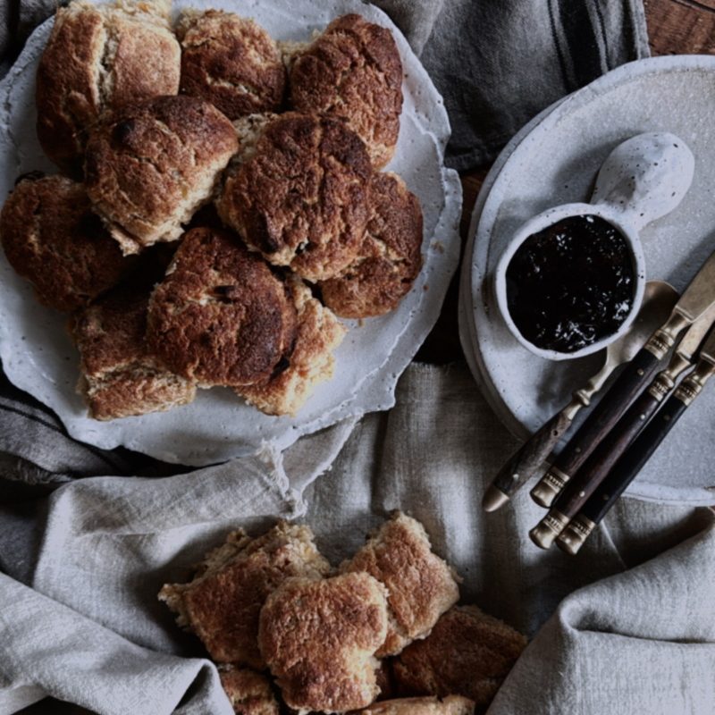 Freshly baked scones on ceramic plate.