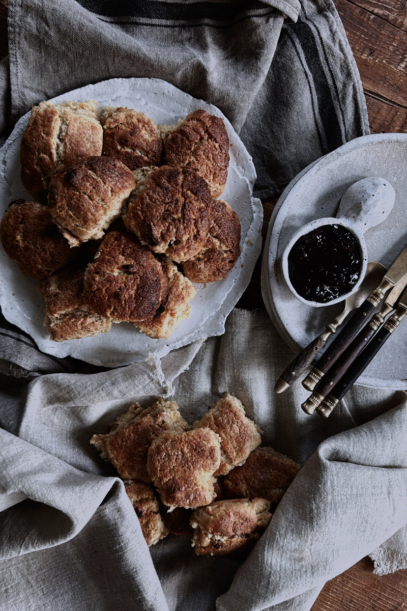 Freshly baked scones on ceramic plate.