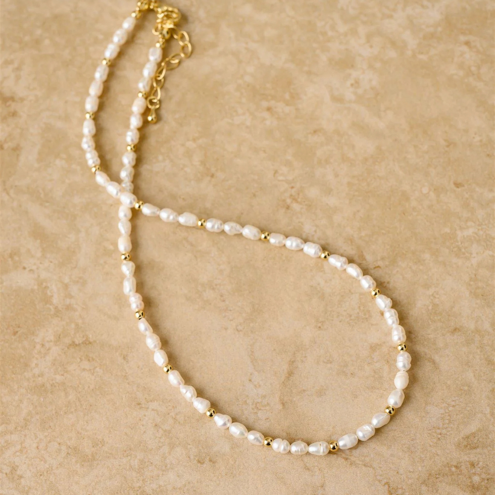 Indigo & Wolfe LACEY freshwater pearl necklace with gold accents on neutral background, shop online at Tomolly.