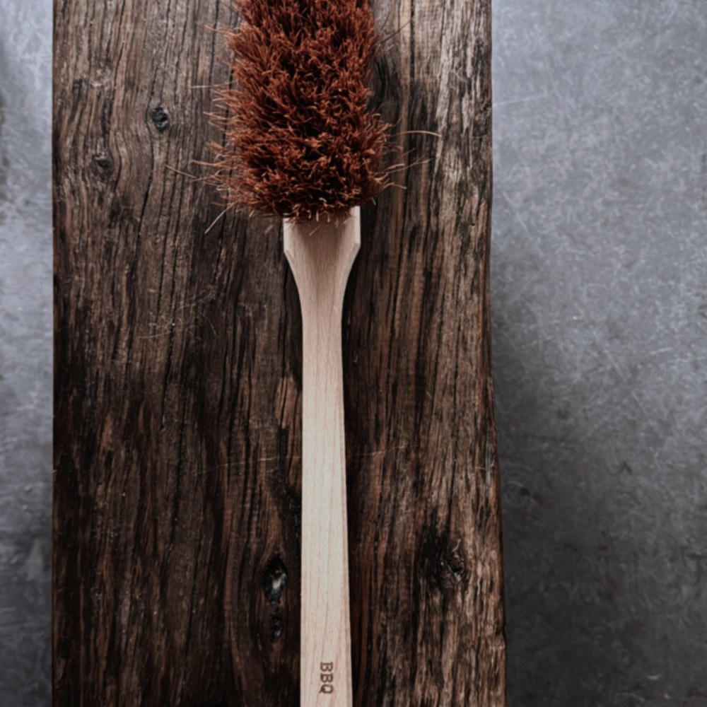 A natural BBQ brush by Redecker, crafted with coconut fibre bristles and a sturdy wooden handle.