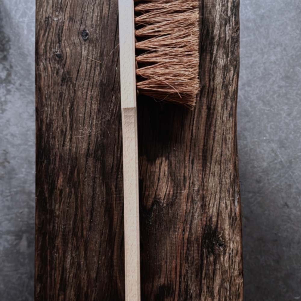 A natural BBQ brush by Redecker, crafted with coconut fibre bristles and a sturdy wooden handle.